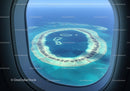 Aerial View of Overwater Bungalows on Tropical Island with Blue Ocean