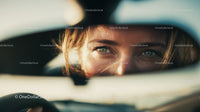 Close-up of Woman with Blue Eyes Looking Through Car Mirror