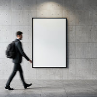 Businessman walking past blank poster on concrete wall