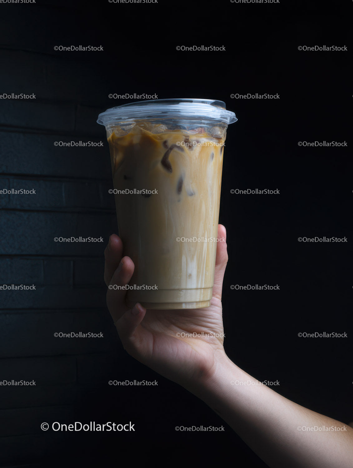 Chilled Iced Coffee in Clear Plastic Cup with Straw on Dark Background