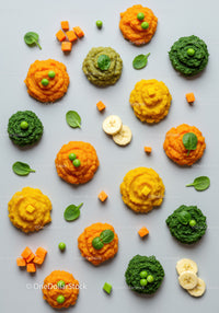 Colorful vegetable and fruit puree dollops with fresh greens