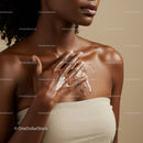 Elegant Black Woman Applying Skin Moisturizer Close-up