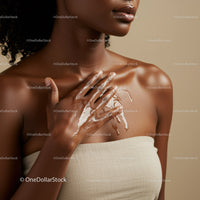 Elegant Black Woman Applying Skin Moisturizer Close-up
