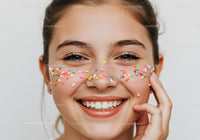 Smiling Girl with Colorful Sprinkles on Face Celebrating Joy and Happiness