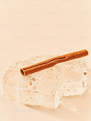 Cinnamon Stick Resting on Clear Ice Cubes