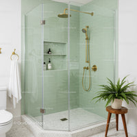 Modern bathroom shower with brass fixtures and greenery