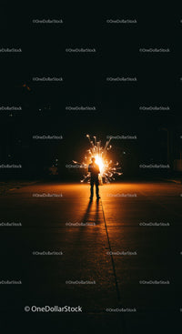Silhouette Holding Sparkler on Dark Night Street