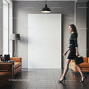 Woman walking past blank canvas in modern living room