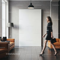 Woman walking past blank canvas in modern living room