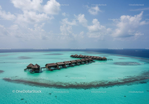 Overwater Bungalows on Turquoise Ocean in Tropical Island Paradise