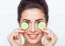 Young Woman Holding Cucumber Slices for Skincare and Beauty