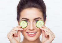 Young Woman Holding Cucumber Slices for Skincare and Beauty