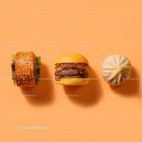 Gourmet Burger with Lettuce and Tomato Next to Grilled Steak and Dumpling