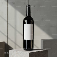 Minimalist wine bottle with blank label on concrete block