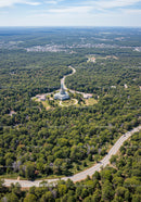 Aerial View of Green Forest and Winding Road Through Scenic Landscape