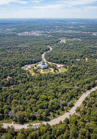 Aerial View of Green Forest and Winding Road Through Scenic Landscape