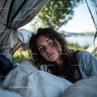 Relaxing Young Woman in Outdoor Tent Near Lake During Summer