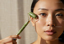 Young Woman Using Jade Roller for Facial Skincare with Natural Glow