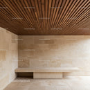 Contemporary Interior with Wooden Ceiling and Beige Stone Walls