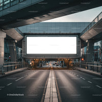 Empty Urban Road beneath Large Illuminated Billboard