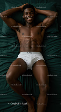 Young man relaxing on bed in white underwear