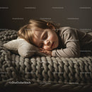 Peaceful toddler sleeping on soft knitted blanket