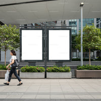Woman walking past blank urban advertising billboards