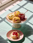 Homemade scones with cream and strawberry jam on plates