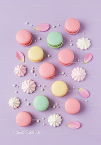 Colorful macarons with meringue and petals on purple
