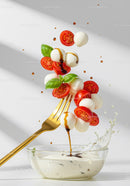 Fresh Caprese Salad Ingredients Flying Over Bowl