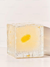 Transparent ice cube with yellow flower inside