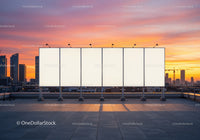Empty Billboards on Rooftop with City Skyline at Sunset