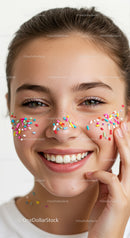 Smiling Young Woman with Colorful Sprinkles on Face for Joyful Portrait