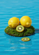 Fresh lemons and kiwi on floating moss in blue water