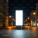 Illuminated blank billboard on empty city street at night