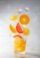 Refreshing Citrus Cocktail with Floating Fruit and Ice Cubes