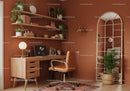Cozy home office with warm terracotta walls and natural wood