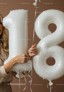 Woman Holding White Number 18 Birthday Balloons