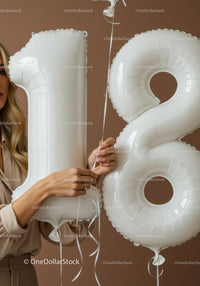 Woman Holding White Number 18 Birthday Balloons