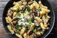 Beef Stroganoff with Mushrooms and Fettuccine on Wooden Table