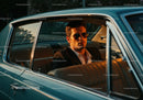 Stylish Man in Sunglasses Driving Vintage Car in Sunset Light