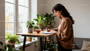 Young woman writing notes by window in cozy home