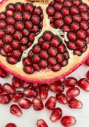 Close up of fresh pomegranate seeds and fruit half