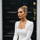Elegant woman in white dress with pearl earrings