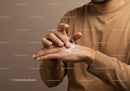 Close-up of Man Applying Lotion on Hands for Skin Care and Moisturizing