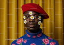 Young man in red beret with daisies on face