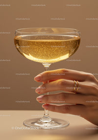 Elegant hand holding sparkling champagne glass