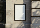 Minimalist blank poster on textured stone wall outdoors