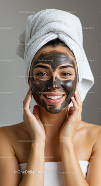 Young Woman Applying Black Facial Mask During Spa Treatment