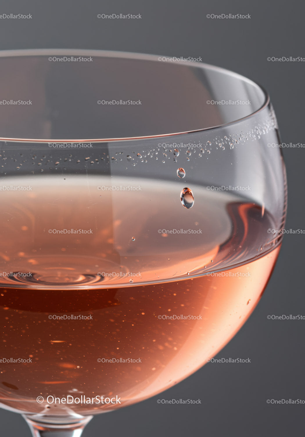 Close up of sparkling rosé wine in clear glass